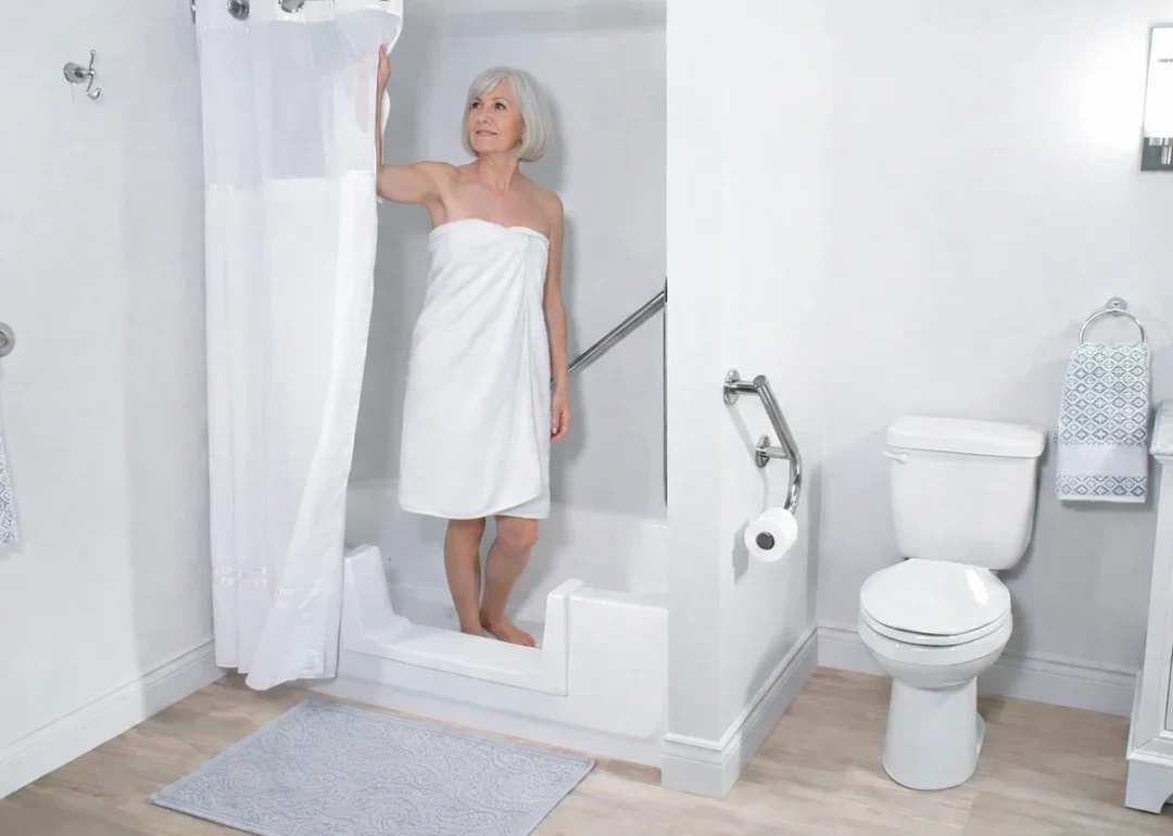 Senior woman safely stepping into bathtub with cutout entry